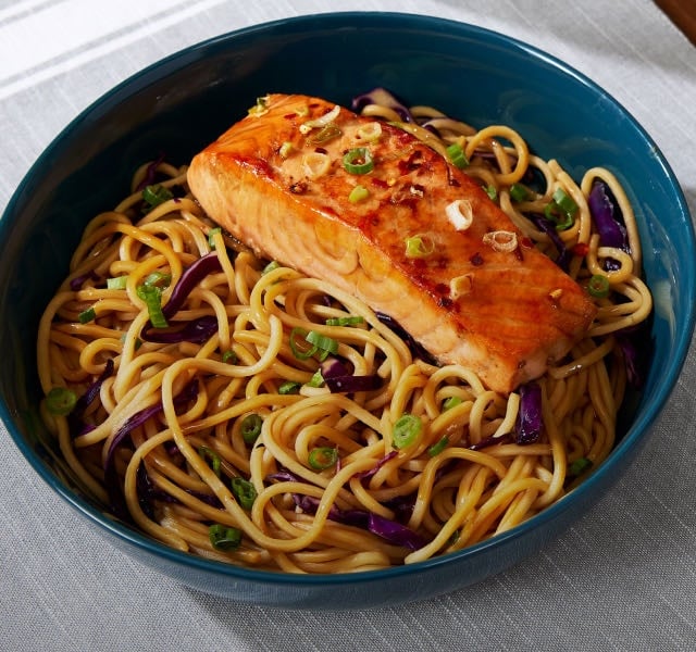 Fried salmon on a bed of teriyaki noodles
